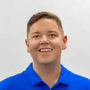 Flexible business professional smiling in a blue polo shirt, representing United Capital Source.