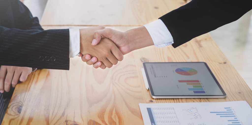 Business investors shaking hands