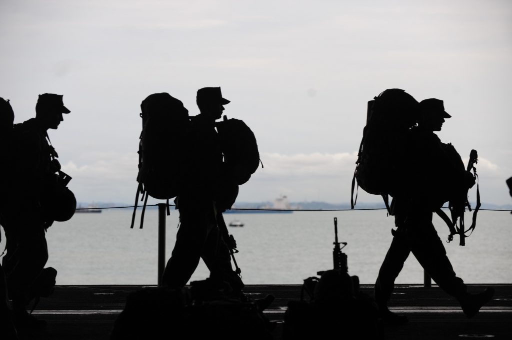 A group of veterans walking together and discussing business loans