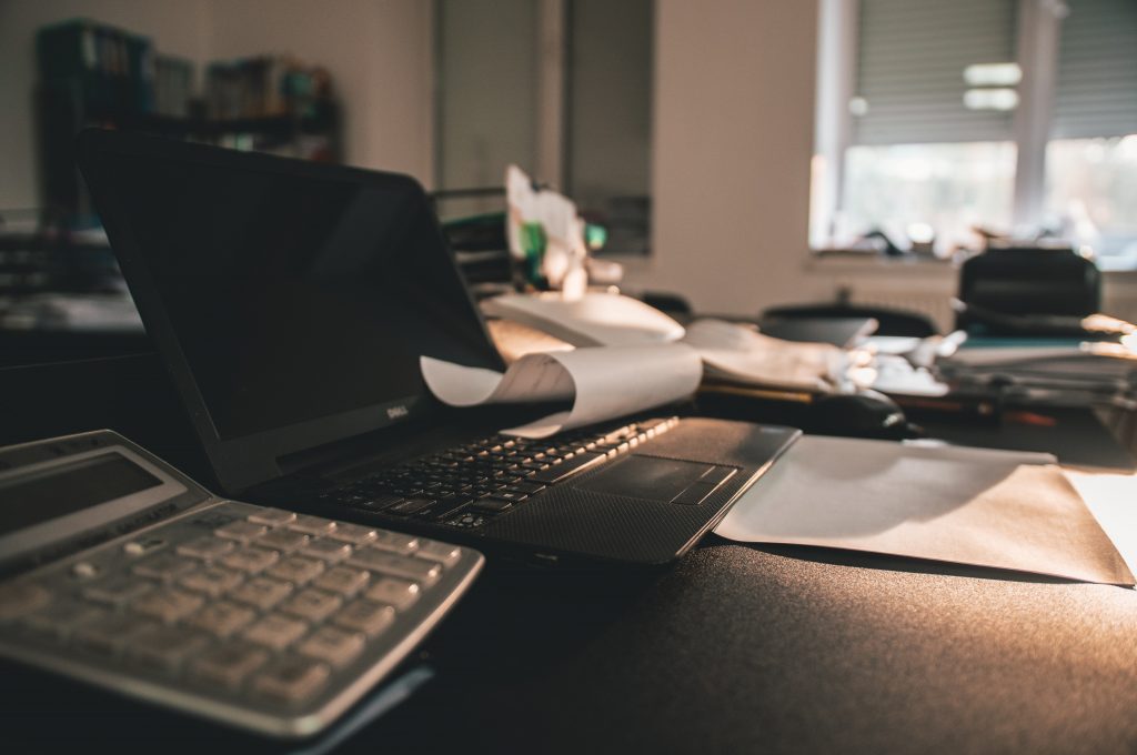 A calculator on a desk computing business taxes