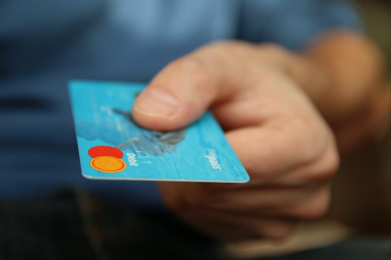 A customer handing a credit card to the merchant for credit card processing