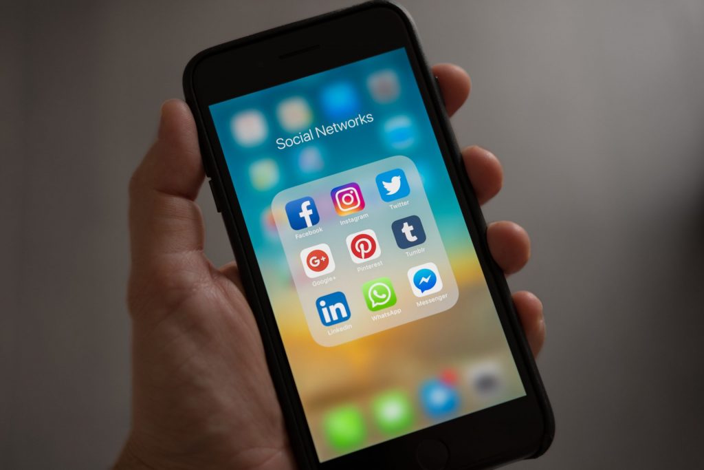 A smartphone with social media apps and how using them can affect your ability to get a business loan