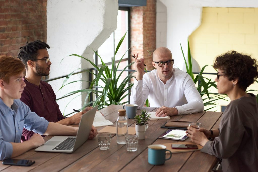 A group of business owners debating the pros and cons of secured vs. unsecured business loans