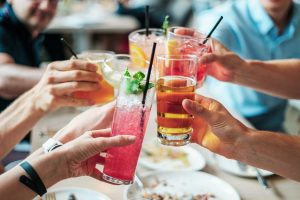 A group of people drinking cocktails from a restaurant that got a business loan