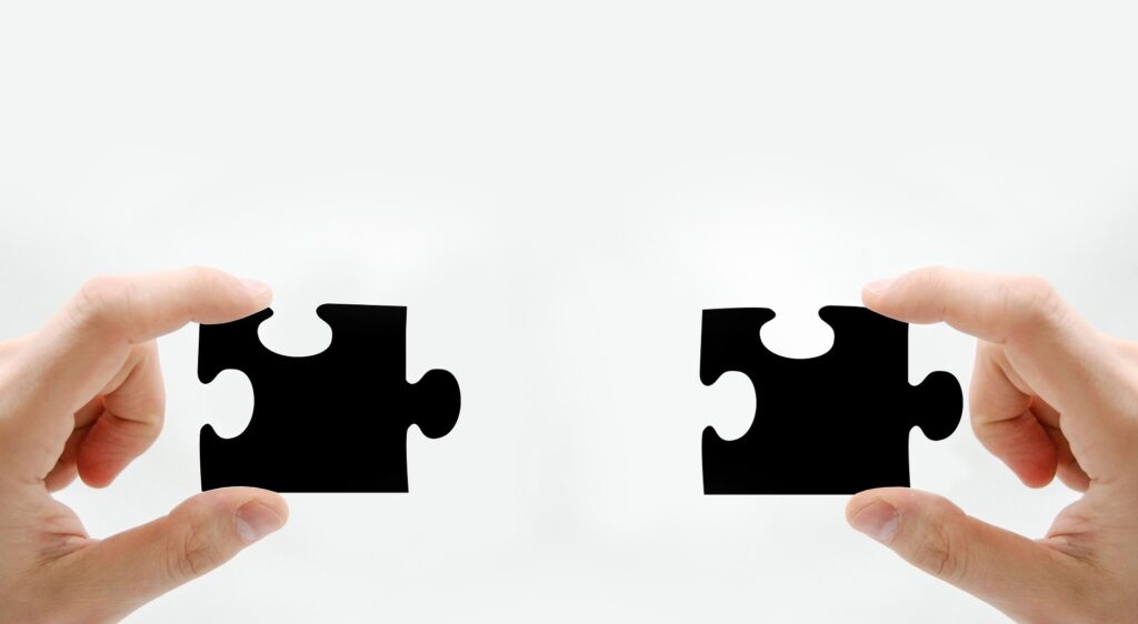 Picture of a left and right hand holding two puzzle pieces. SBA Lender Match Tool