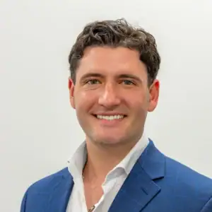 Secure business loan advisor smiling in professional attire for United Capital Source.