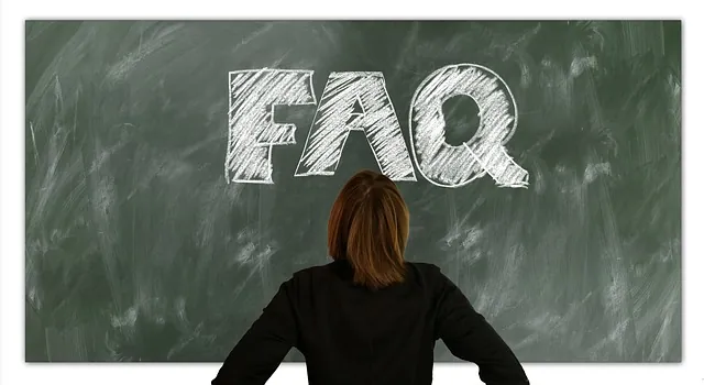 Woman seen from behind facing a green chalkboard with FAQ drawn in large white chalk letters, for ERTC deadline questions